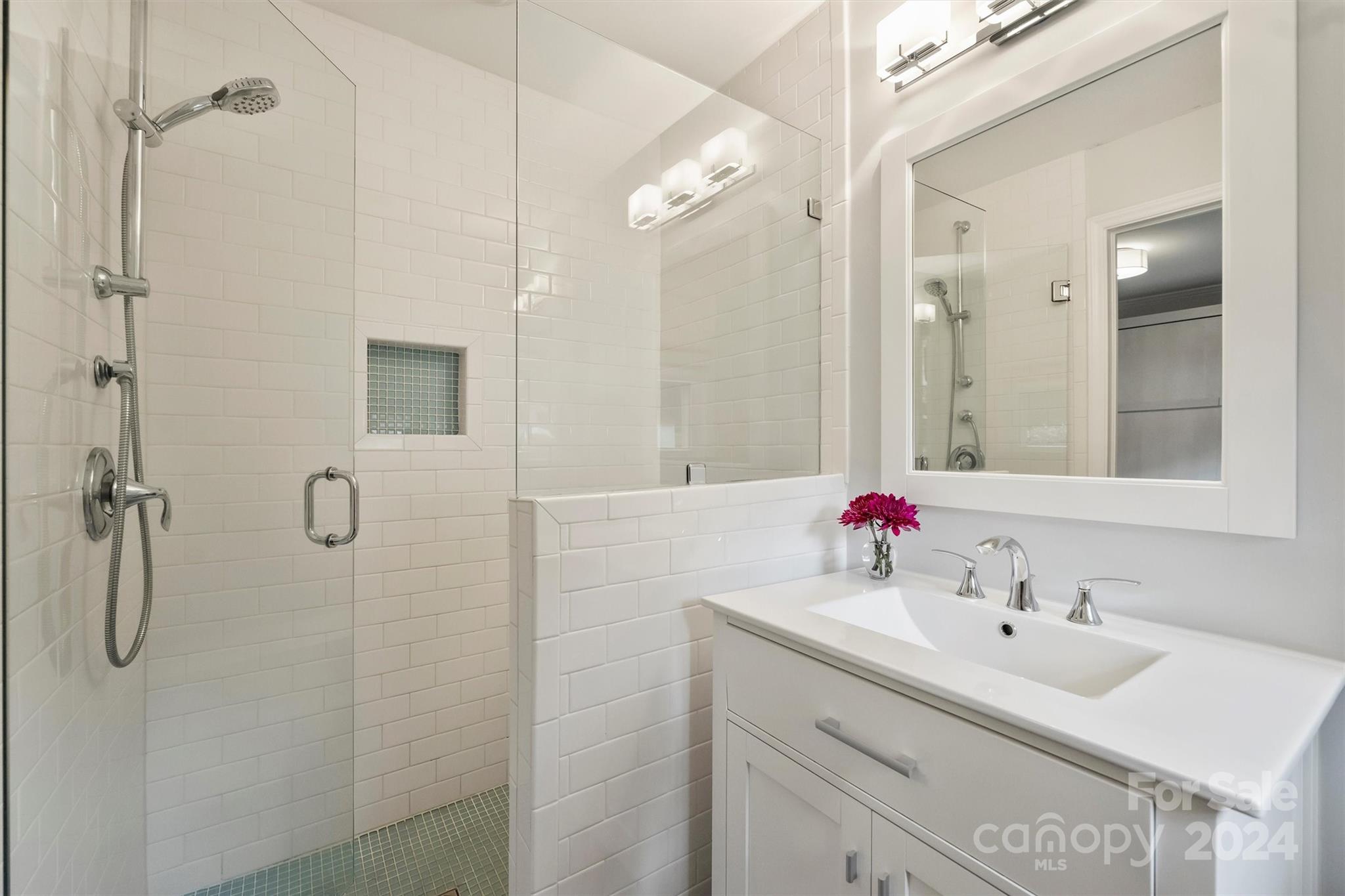 5501 Seacroft Road Charlotte, NC 28210 - Photo 23 of 37 a bathroom with a double vanity sink a shower and a mirror