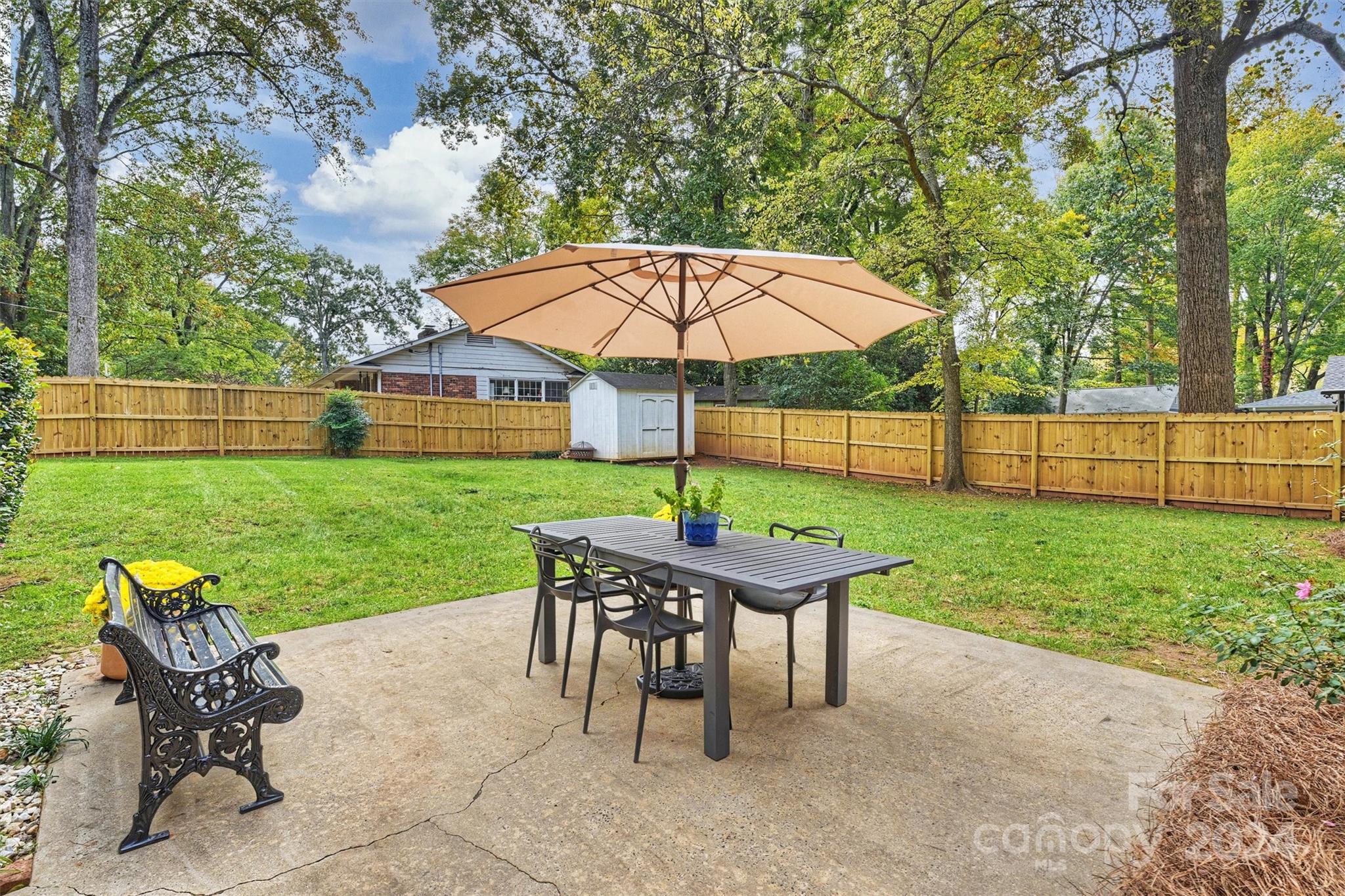 5501 Seacroft Road Charlotte, NC 28210 - Photo 32 of 37 a view of a deck with a table and chairs under an umbrella