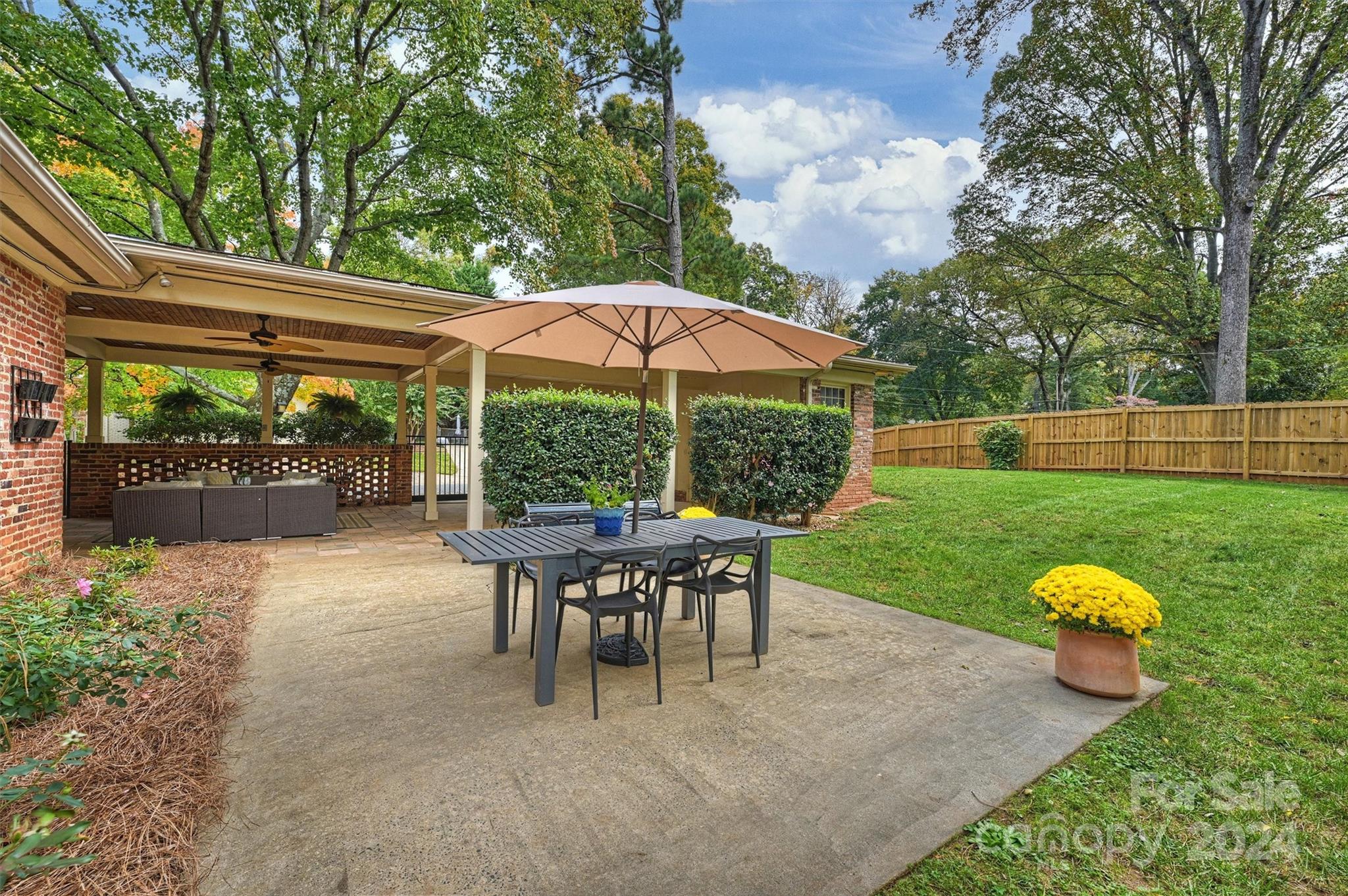 5501 Seacroft Road Charlotte, NC 28210 - Photo 33 of 37 a view of a table and chairs in backyard of the house