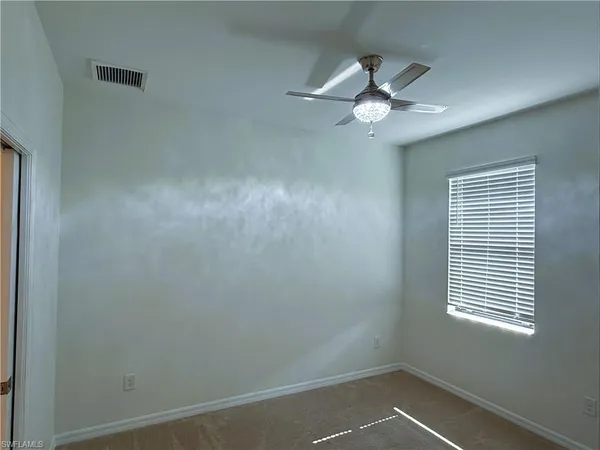 a view of a livingroom with a ceiling fan and window