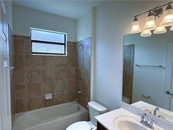 a bathroom with a toilet a sink and bathtub