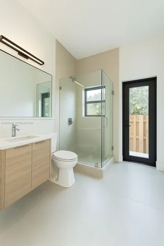 a bathroom with a toilet sink and shower