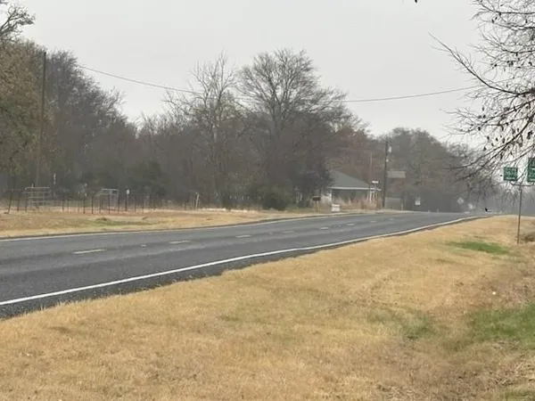 a view of a street with a cars parked on the road