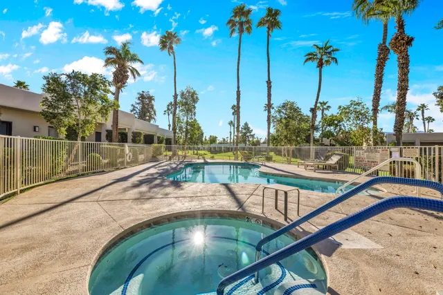 a view of a swimming pool with a table and chairs