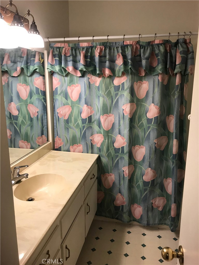 1203 Edgewood Lane Upland, CA 91786 - Photo 7 of 11 a bathroom with a sink and mirror with shower