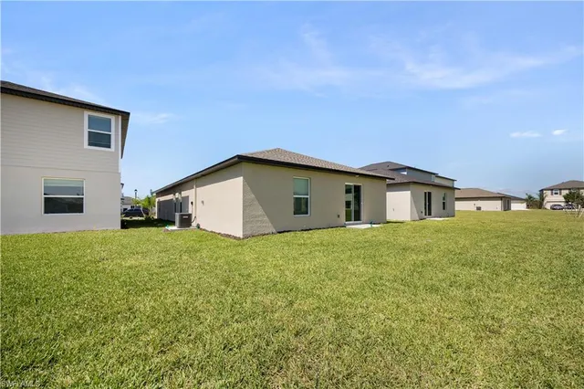 an aerial view of a house with a lake view