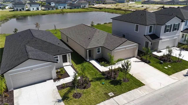 an aerial view of a house with a garden and lake view