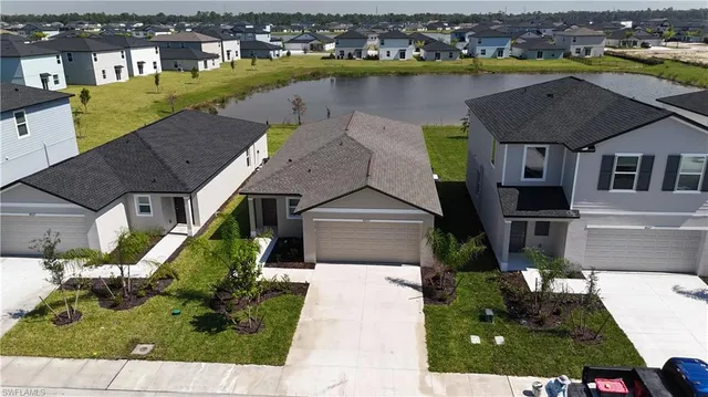 an aerial view of a house with a garden and lake view
