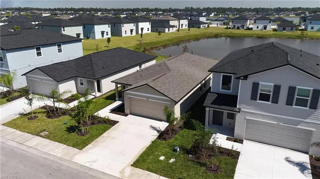 an aerial view of residential houses with yard