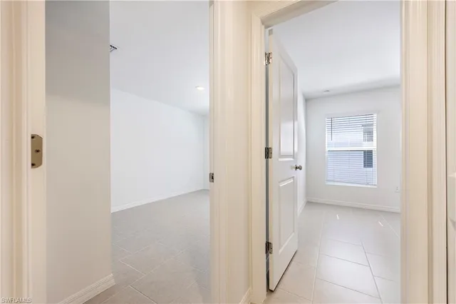 a view of a hallway with wooden shelves