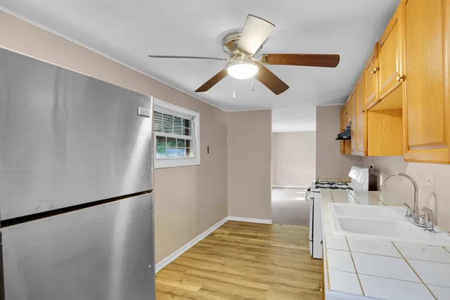 a bathroom with a sink and a refrigerator