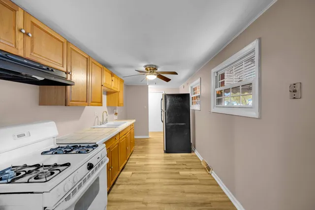 a kitchen with granite countertop a stove and a refrigerator
