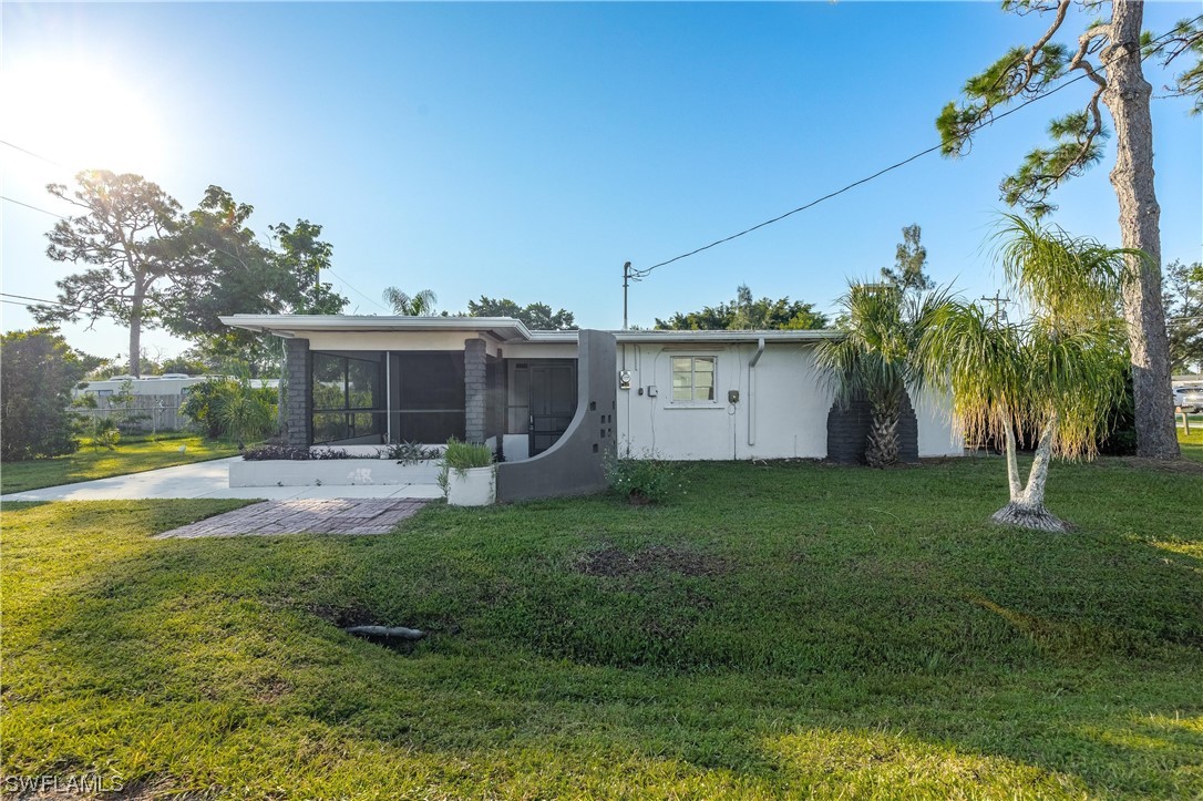 a view of a house with backyard and sitting area