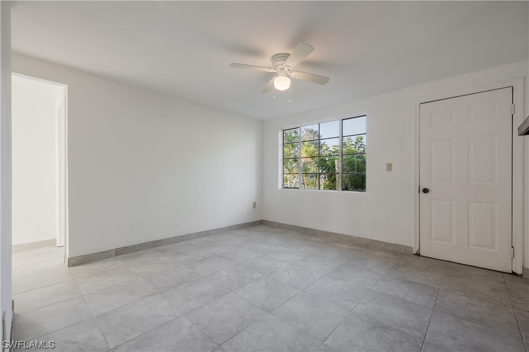 1338 Old Bridge Road North Fort Myers, FL 33917 - Photo 15 of 33 an empty room with windows and chandelier fan