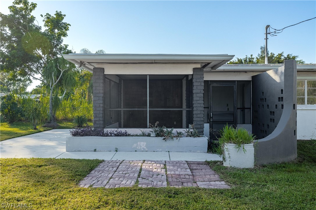 1338 Old Bridge Road North Fort Myers, FL 33917 - Photo 2 of 33 a front view of a house with a garden