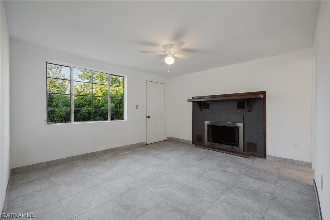 1338 Old Bridge Road North Fort Myers, FL 33917 - Photo 22 of 33 a view of an empty room with a fireplace and a window