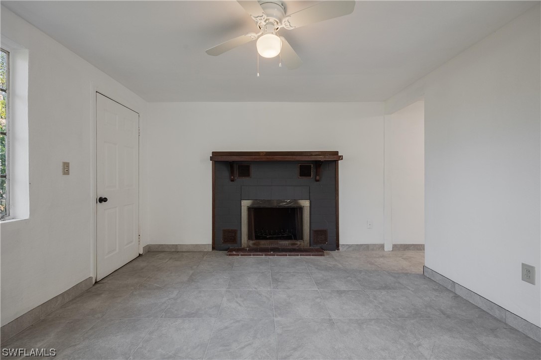 1338 Old Bridge Road North Fort Myers, FL 33917 - Photo 23 of 33 an empty room with fireplace and fan