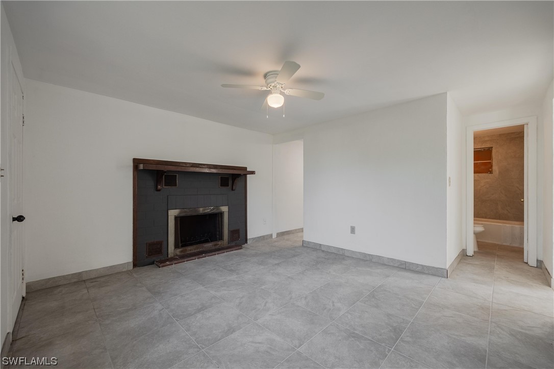 1338 Old Bridge Road North Fort Myers, FL 33917 - Photo 24 of 33 an empty room with a fireplace and fan