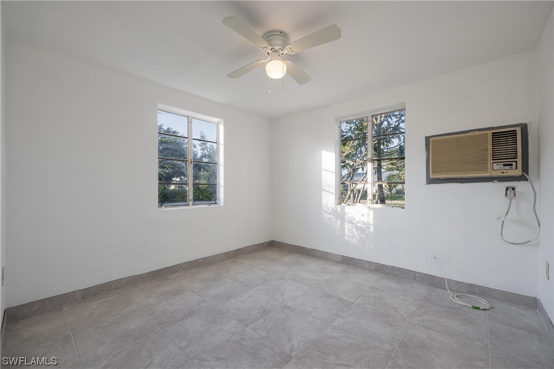 1338 Old Bridge Road North Fort Myers, FL 33917 - Photo 7 of 33 an empty room with windows and fan