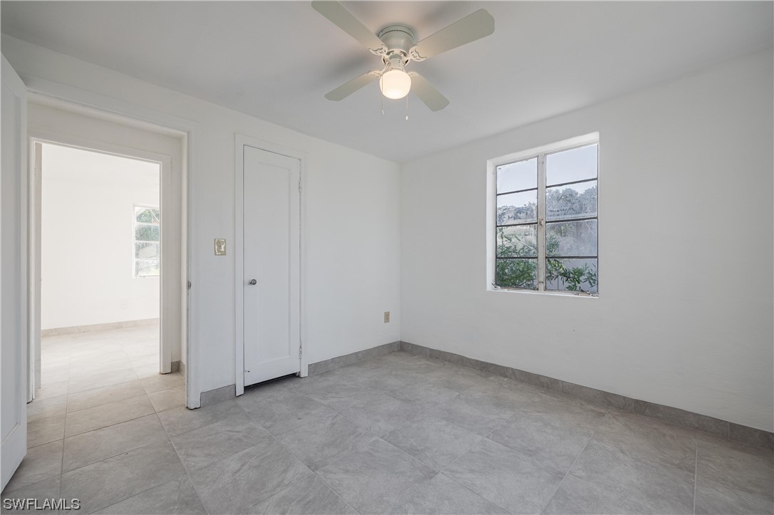 1338 Old Bridge Road North Fort Myers, FL 33917 - Photo 8 of 33 an empty room with a window and a fan