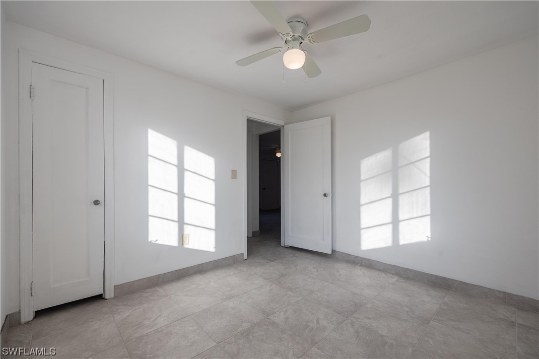 1338 Old Bridge Road North Fort Myers, FL 33917 - Photo 10 of 33 an empty room with windows and fan
