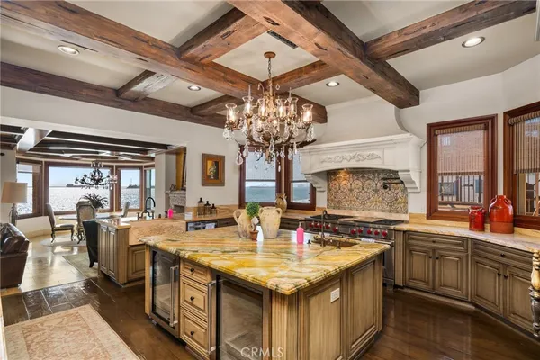 a kitchen with kitchen island granite countertop a stove and a sink