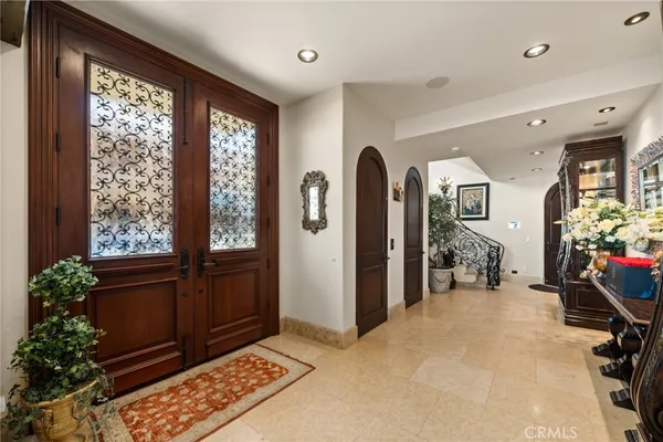 a view of staircase with lots of frames on wall and a chandelier
