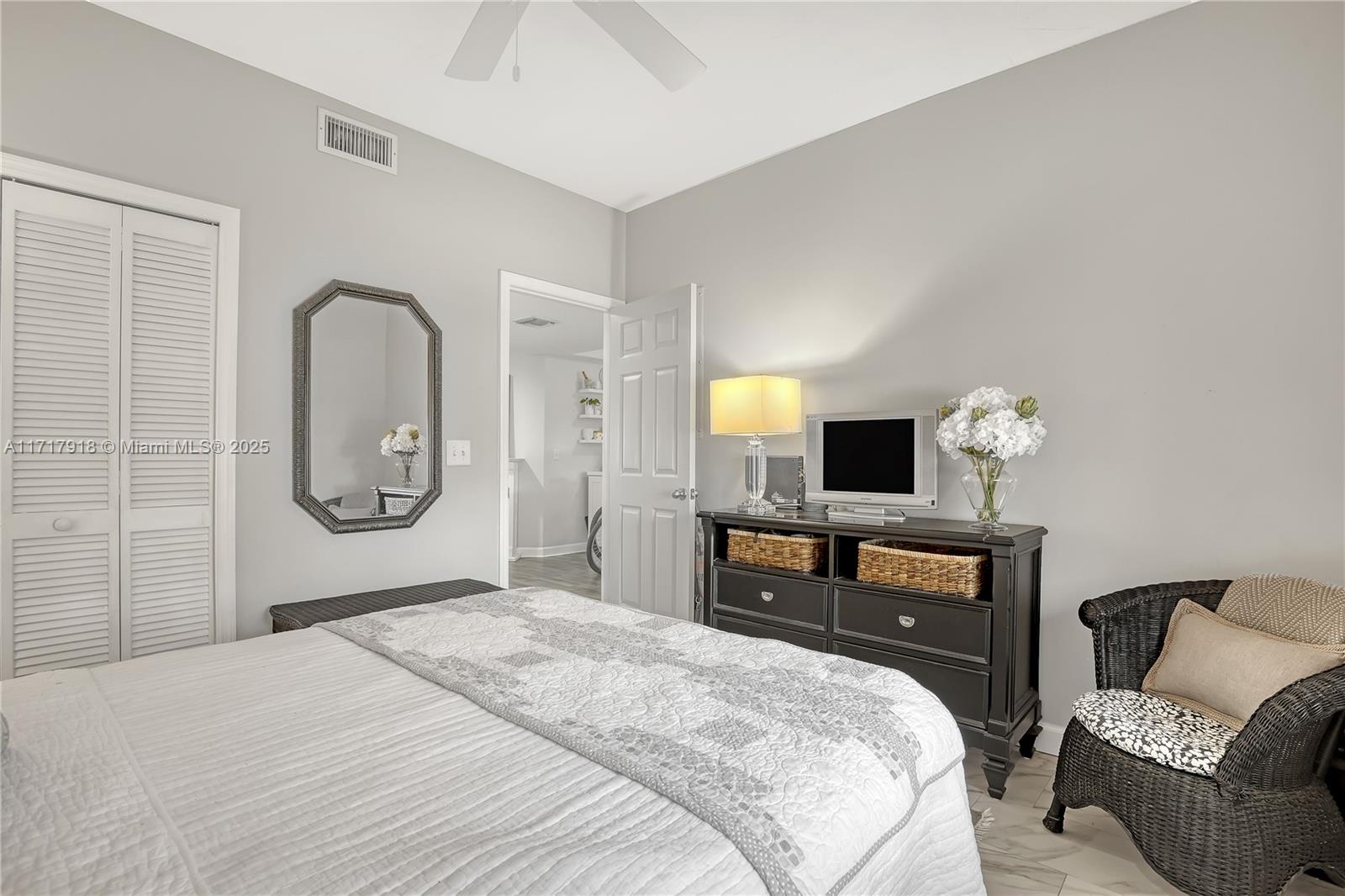 6102 Southeast Landing Way, Unit 2 Stuart, FL 34997 - Photo 14 of 44 a bedroom with a bed and dresser