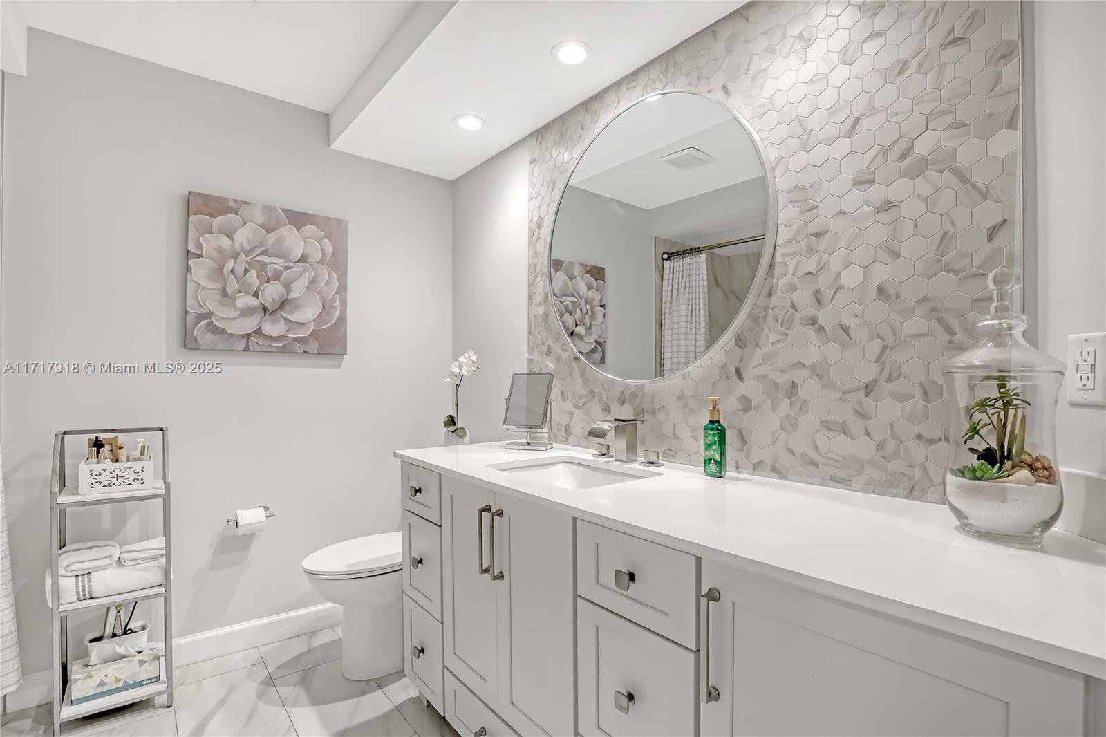 6102 Southeast Landing Way, Unit 2 Stuart, FL 34997 - Photo 15 of 44 a spacious bathroom with a toilet sink and mirror