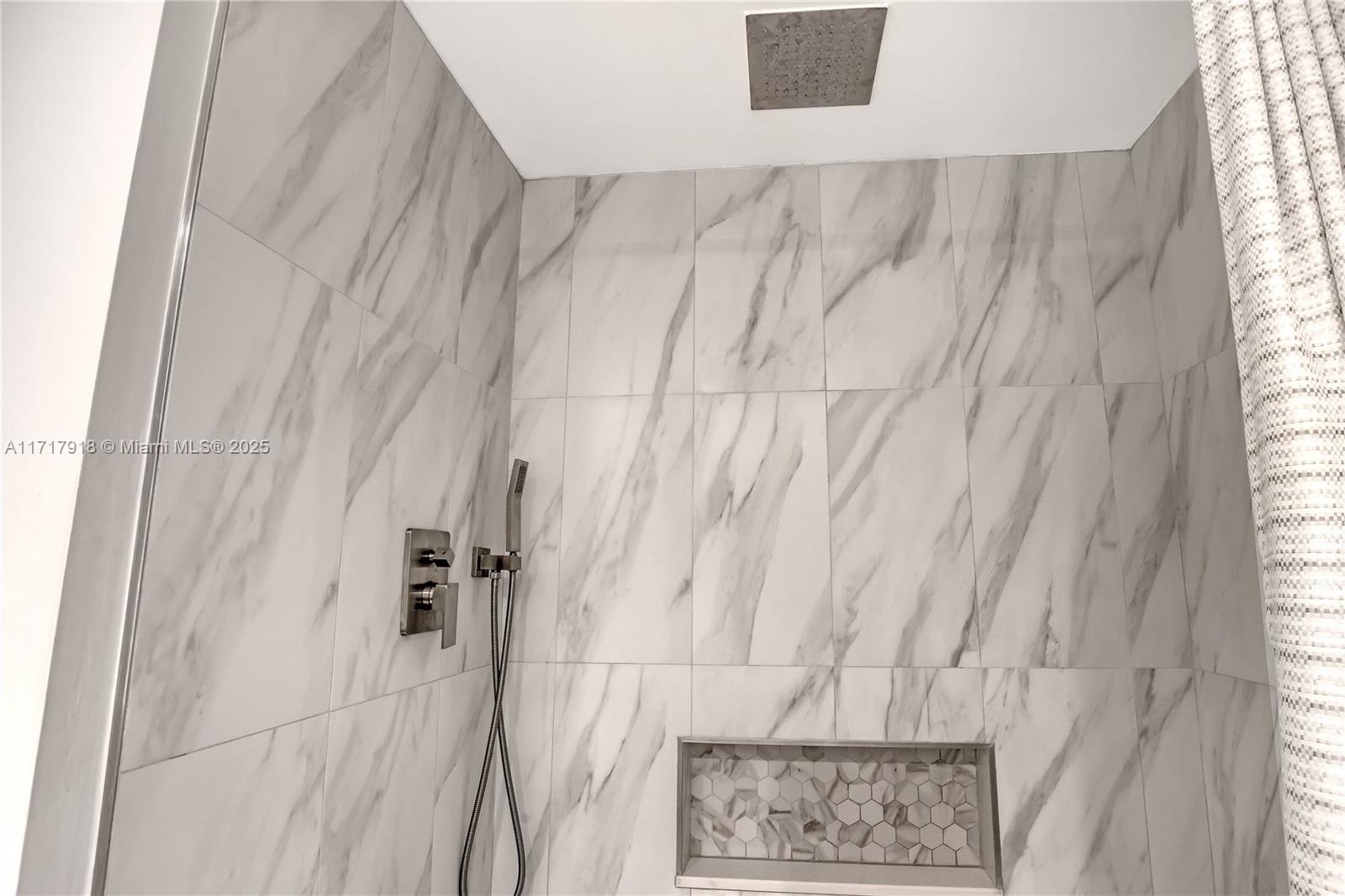 6102 Southeast Landing Way, Unit 2 Stuart, FL 34997 - Photo 17 of 44 a bathroom with a shower curtain and a window