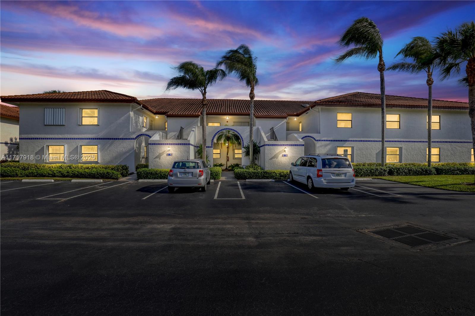 6102 Southeast Landing Way, Unit 2 Stuart, FL 34997 - Photo 2 of 44 a couple of cars parked in front of a building