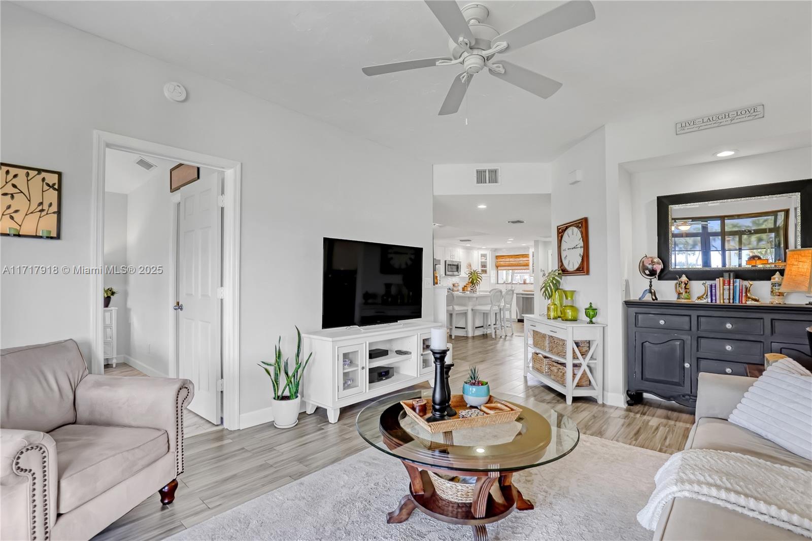 6102 Southeast Landing Way, Unit 2 Stuart, FL 34997 - Photo 21 of 44 a living room with furniture and a flat screen tv