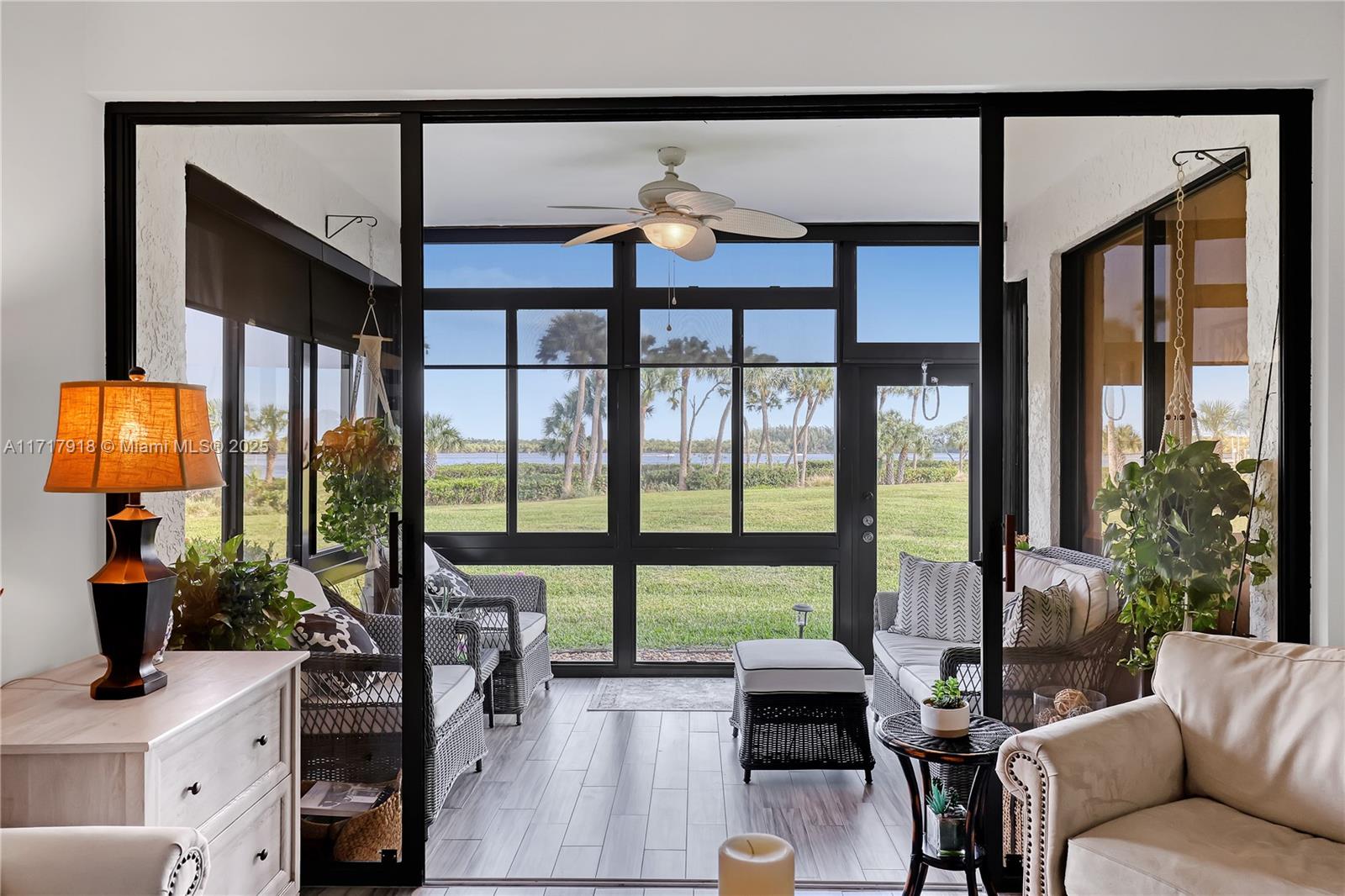 6102 Southeast Landing Way, Unit 2 Stuart, FL 34997 - Photo 23 of 44 a living room with furniture and a large window