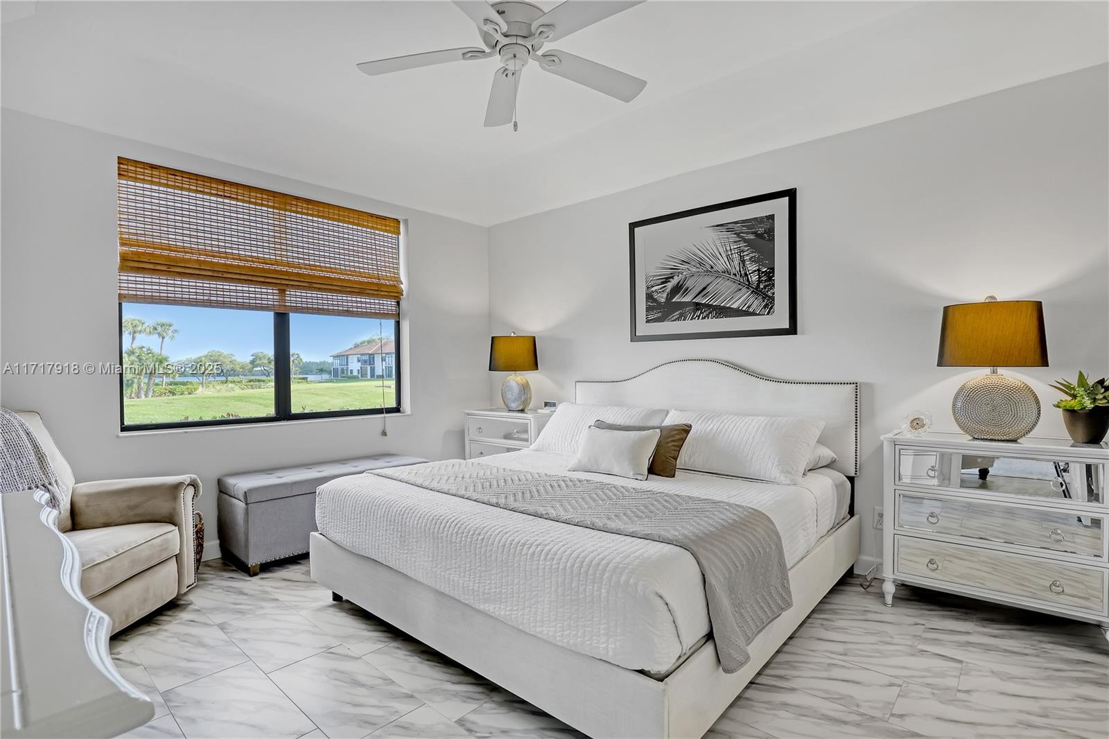 6102 Southeast Landing Way, Unit 2 Stuart, FL 34997 - Photo 25 of 44 a bedroom with a bed and a couch