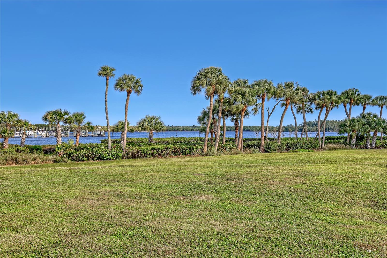 6102 Southeast Landing Way, Unit 2 Stuart, FL 34997 - Photo 29 of 44 a view of a swimming pool and a yard
