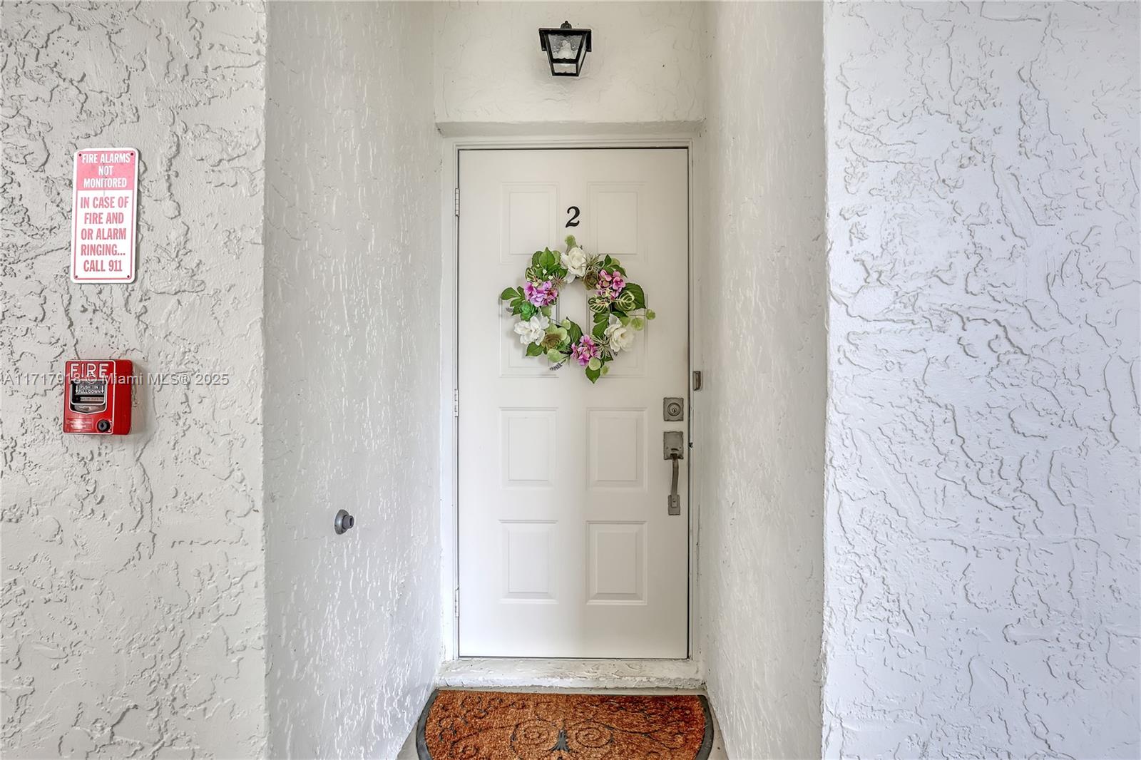 6102 Southeast Landing Way, Unit 2 Stuart, FL 34997 - Photo 3 of 44 a hallway with painting and wooden floor