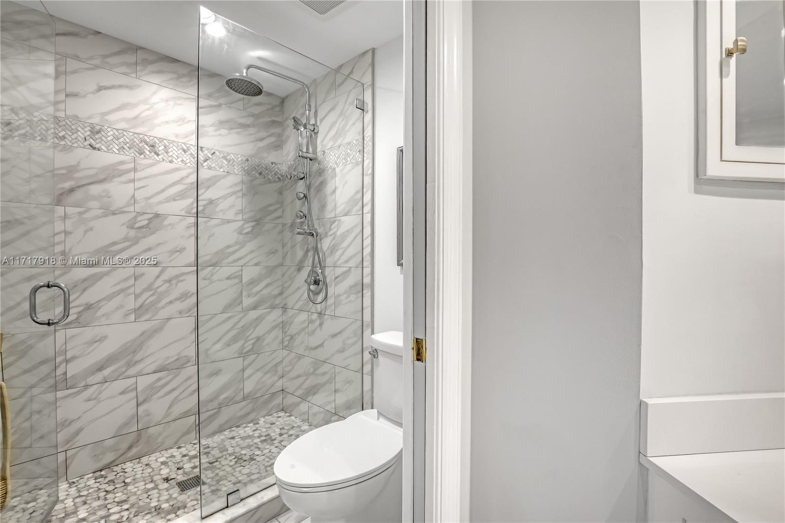 6102 Southeast Landing Way, Unit 2 Stuart, FL 34997 - Photo 31 of 44 a bathroom with a toilet and a shower