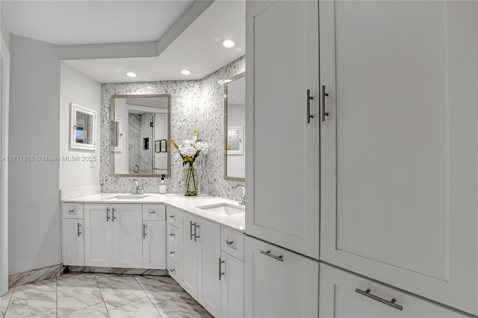 6102 Southeast Landing Way, Unit 2 Stuart, FL 34997 - Photo 32 of 44 a bathroom with a double vanity sink and mirror