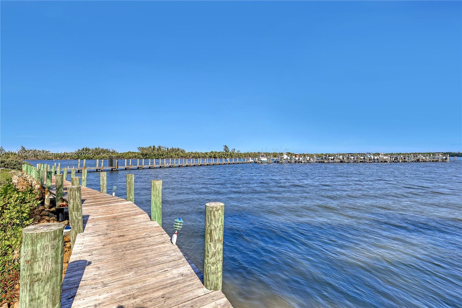6102 Southeast Landing Way, Unit 2 Stuart, FL 34997 - Photo 34 of 44 a view of a balcony with wooden floor and city view
