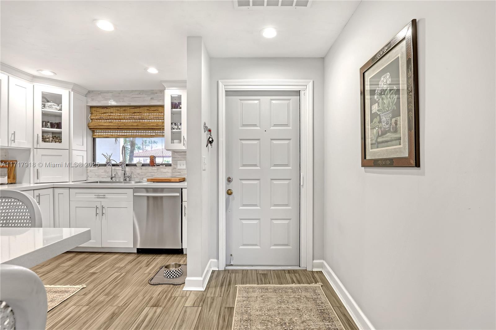 6102 Southeast Landing Way, Unit 2 Stuart, FL 34997 - Photo 4 of 44 a bathroom with a sink and a mirror