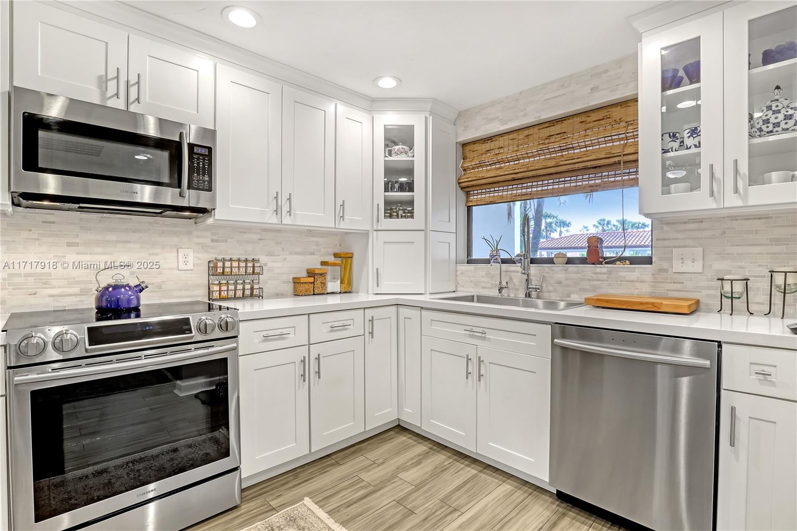 6102 Southeast Landing Way, Unit 2 Stuart, FL 34997 - Photo 5 of 44 a kitchen with cabinets stainless steel appliances and a sink