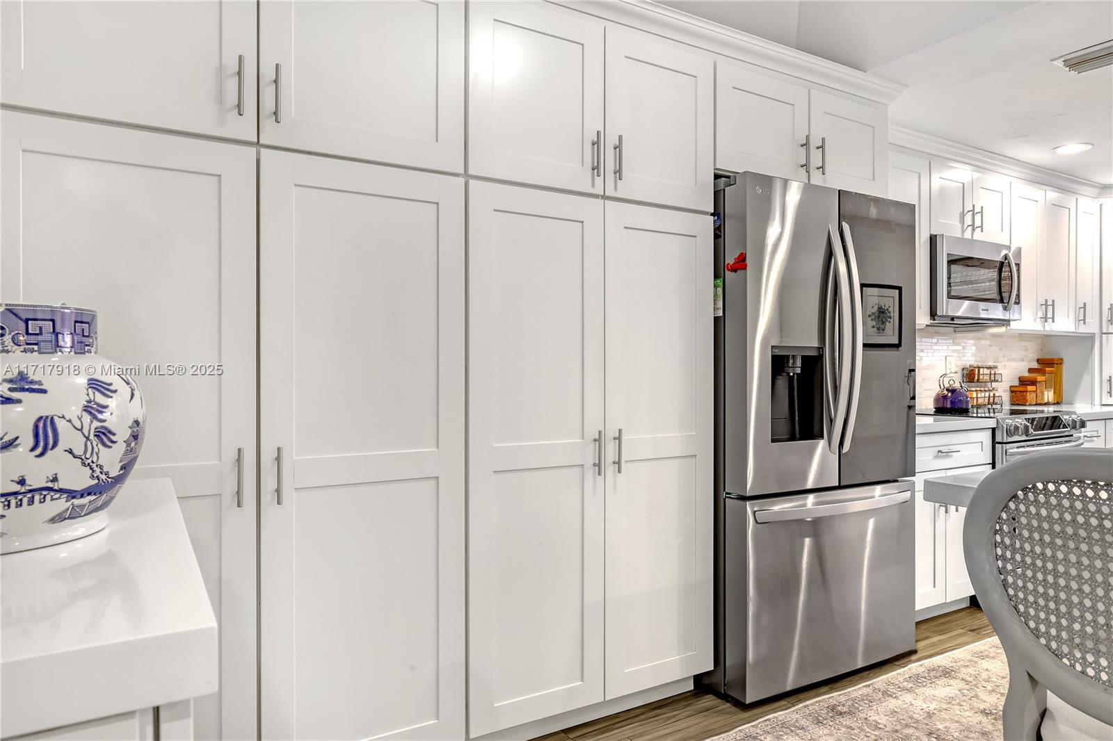 6102 Southeast Landing Way, Unit 2 Stuart, FL 34997 - Photo 9 of 44 a metallic refrigerator freezer sitting in a kitchen