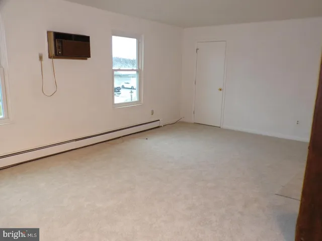 a view of a livingroom with a dishwasher cabinets and a window