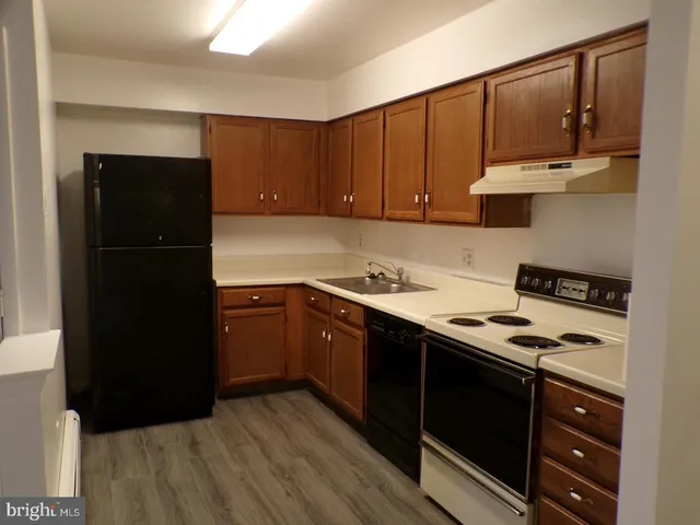 a kitchen with stainless steel appliances granite countertop a refrigerator a stove and a refrigerator