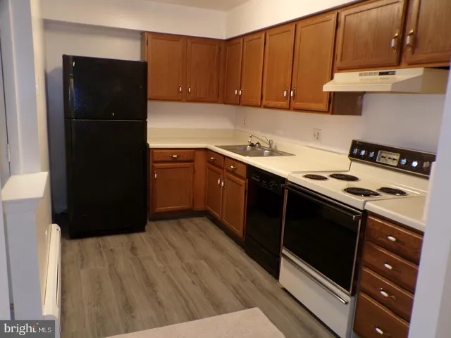 a kitchen with a refrigerator stove and cabinets