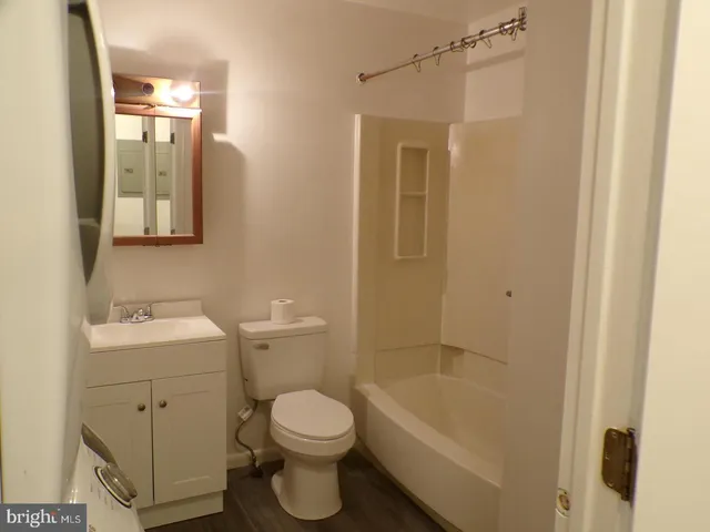a bathroom with a toilet a sink and mirror