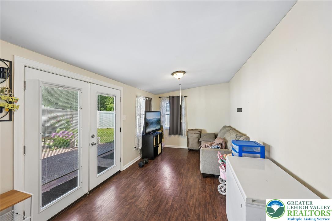 2649 Nottingham Road Bethlehem, PA 18017 - Photo 14 of 49 Laminate flooring extends into a spacious living area, highlighted by patio doors offering views of the yard.