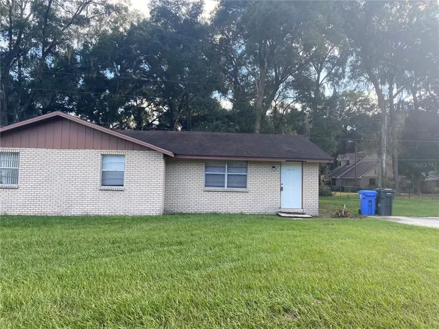 a front view of house with yard and trees