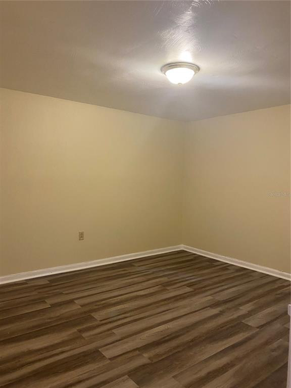 12007 Homerville Lane Seffner, FL 33584 - Photo 11 of 15 a view of an empty room with wooden floor