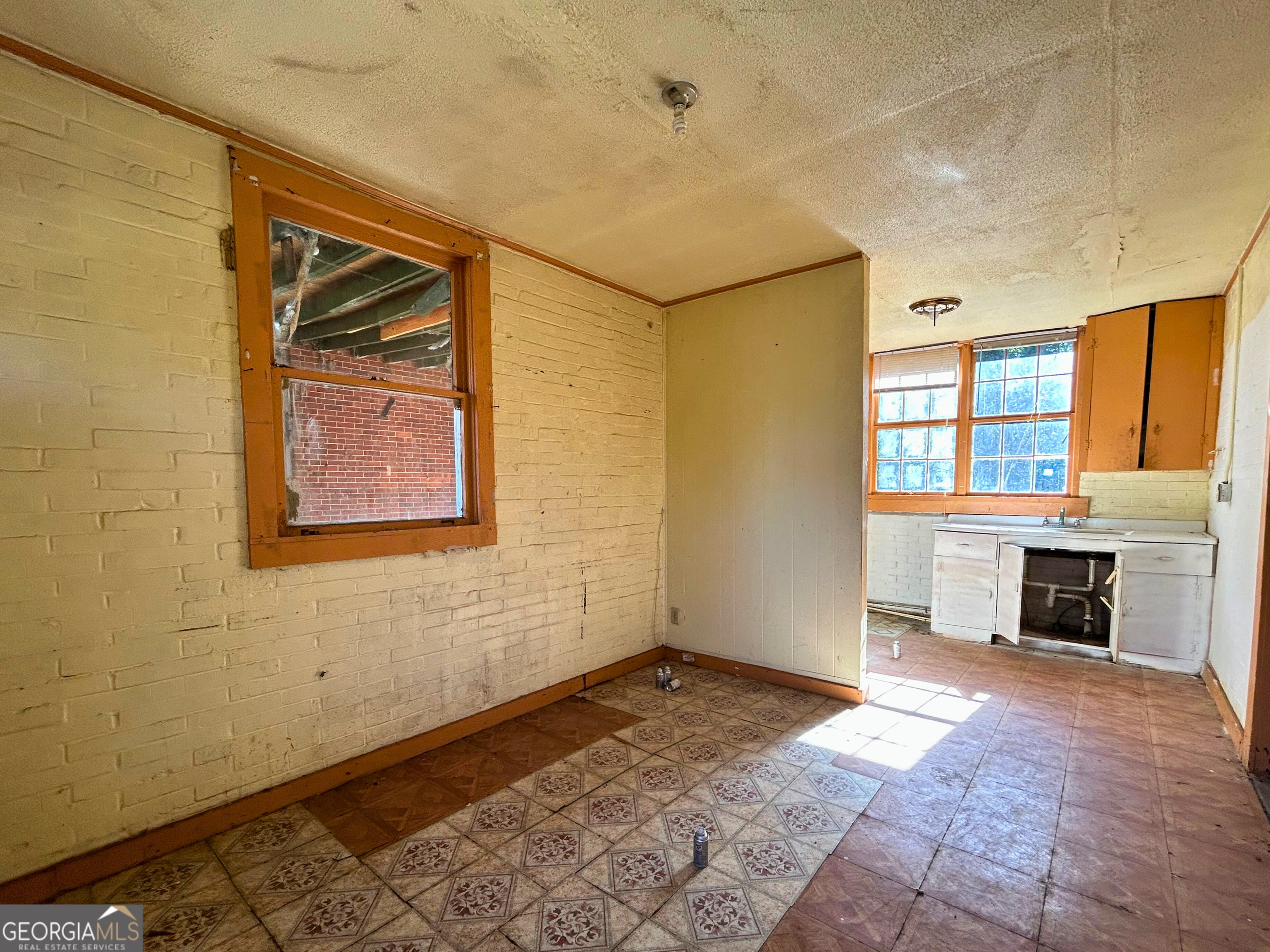 806 Magnolia Drive Macon, GA 31217 - Photo 23 of 25 a view of an empty room with a fireplace and a window
